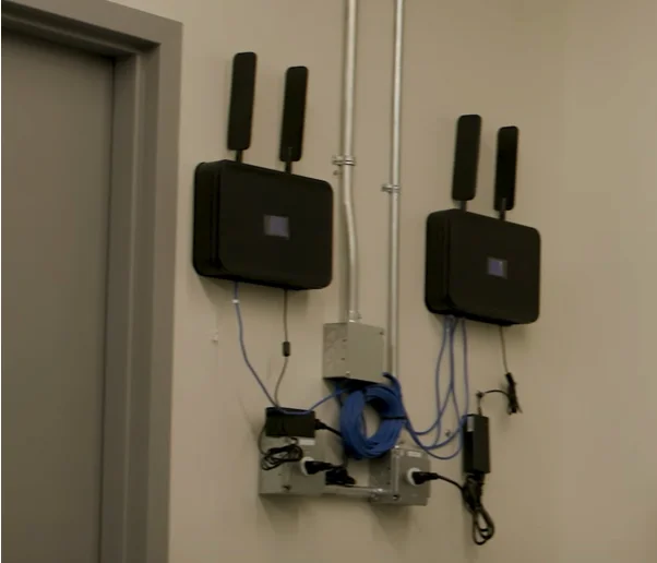 Two Ooma AirDials mounted and wired on a wall board